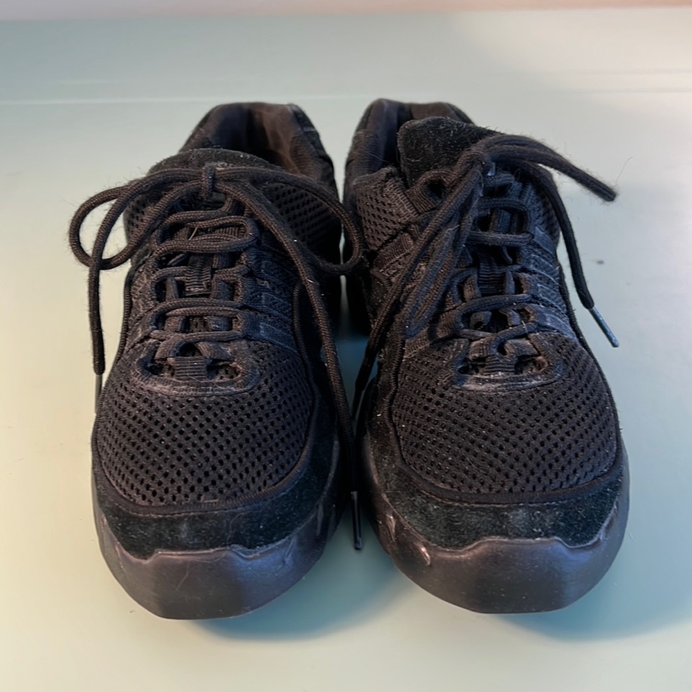Bloch black dance sneakers.  Suede trim but primarily synthetic materials.
